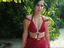 a woman in a red crop top and skirt