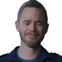 a man with a beard is making a sad face with his eyes closed