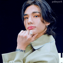 a close up of a person 's face with a ring on it