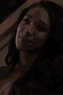 a close up of a woman 's face with a smile on her face .