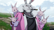 a group of rabbits are standing around a man in a kimono
