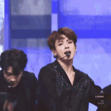 a man with a microphone in his mouth and the word laundry on the bottom right