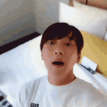 a man wearing a white shirt with a puma logo on it