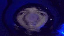 a blurry picture of a person 's face with a blue light in the background