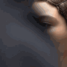 a close up of a woman smoking a cigarette in her mouth