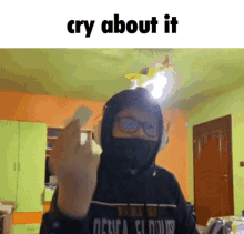 a man wearing a mask and headphones is giving the middle finger and the words cry about it are above him