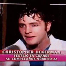 a man is talking into a microphone with the name christopher uckerman on the bottom