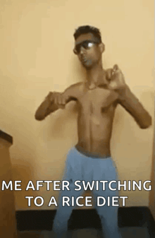 a shirtless man wearing sunglasses is standing in front of a wall and says me after switching to a rice diet .