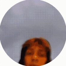 a blurry picture of a woman 's face is in a circle