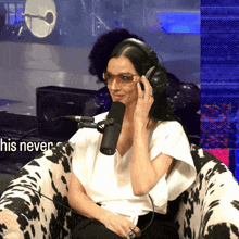 a woman wearing headphones is sitting in front of a microphone with the words his never on the bottom