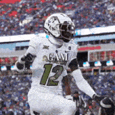 a football player in a white uniform with the number 12 on it