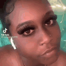 a close up of a woman 's face with a tiktok account visible