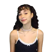 a woman with curly hair wearing a polka dot tank top and a pearl necklace