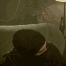 a person wearing black gloves making a heart with their hands