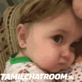 a baby is being held in a woman 's arms with the words tamilchatroom.in written below it
