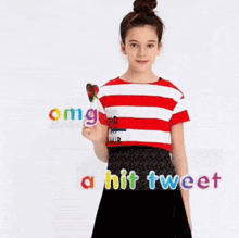 a girl in a red and white striped shirt is holding a lollipop and says omg a hit tweet