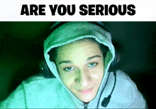a person wearing a hoodie and headphones with the words are you serious above them