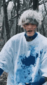 a person with blue paint on their face and body