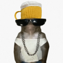 a monkey wearing sunglasses and a hat with a beer mug on top of it