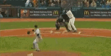 a baseball game is being played with a mcdonald 's ad in the background