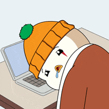 a cartoon of a person wearing an orange beanie laying on a desk in front of a laptop