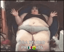 a very fat woman is sitting in a chair with her arms outstretched and says `` bba studio presents '' .