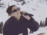 a woman singing into a microphone in the snow