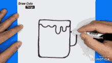 a person is drawing a cup with a marker on a piece of paper