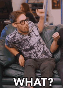 a man is sitting on a couch with the word what written on the bottom