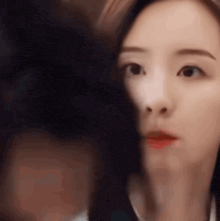 a close up of a woman 's face looking at the camera .