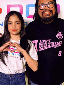 a man and a girl are posing for a picture with the girl wearing a shirt that says happy birthday