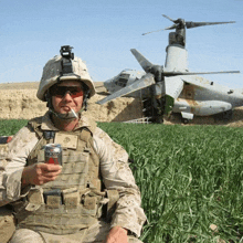 a man in a military uniform holds a can of diet coke