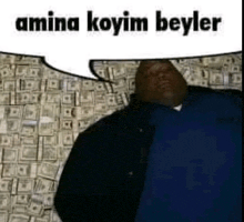 a man in a blue shirt is laying on a pile of money .