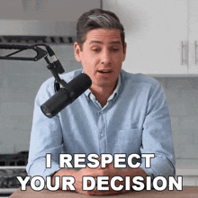 a man sitting in front of a microphone with the words " i respect your decision " above him