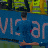 a man wearing a number 20 jersey holds his fist up in the air