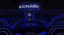 a woman stands on a stage in front of a logo for millonario