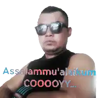 a man wearing sunglasses and a black tank top with the words assalamu ' alaikum cooooyy