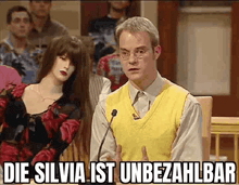 a man in a yellow vest is standing in front of a microphone .