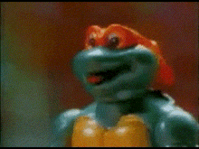 a close up of a toy turtle with its tongue hanging out