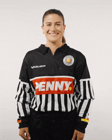a woman is wearing a black and white jersey with penny on the front