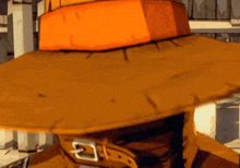 a close up of a person wearing an orange hat with a buckle on it