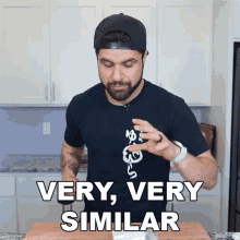 a man wearing a black shirt with a snake on it says very very similar