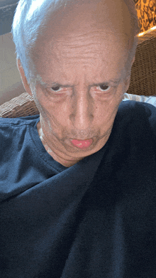 a man with gray hair and a black shirt is making a funny face