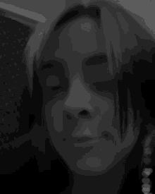 a black and white photo of a woman 's face with a man 's hand on her head .