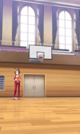 a girl stands in front of a basketball hoop