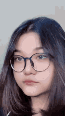 a close up of a girl wearing glasses
