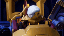 a lego figure is sitting in a chair with a white turban on his head
