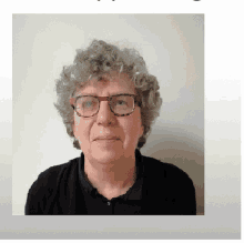 a woman wearing glasses and a black shirt