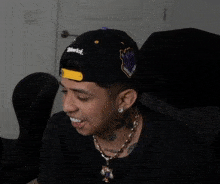 a young man wearing a black hat that says wmarck