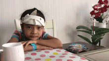 a little girl sits at a table in front of a sign that says youtube